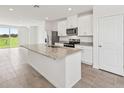 Bright kitchen with large island, stainless steel appliances, and an open layout at 14115 Crutchfield Ct, Parrish, FL 34219