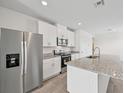 Modern kitchen with stainless steel appliances, granite countertops, and ample cabinet space at 14115 Crutchfield Ct, Parrish, FL 34219
