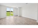 Spacious living room featuring tile flooring and sliding glass doors leading to the backyard at 14115 Crutchfield Ct, Parrish, FL 34219
