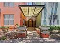 Building entrance featuring brick pathway, stone planters, and a covered entryway at 2411 W Horatio St # 537, Tampa, FL 33609