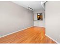Open-concept living room with hardwood floors and a view into the kitchen at 2411 W Horatio St # 537, Tampa, FL 33609