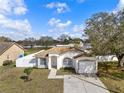 Beautiful single-Gathering home with a manicured lawn, white picket fence, and inviting curb appeal on a sunny day at 4604 Hunts Ave, Plant City, FL 33566