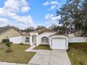 Charming single-story home with a well-maintained lawn, attached garage, and inviting curb appeal under a partly cloudy sky at 4604 Hunts Ave, Plant City, FL 33566