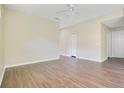 Bright living area featuring wood flooring, white trim, and a large closet at 212 Citrus Landing Dr, Plant City, FL 33563
