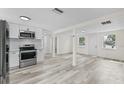 Modern kitchen featuring stainless steel appliances, white cabinets, and new countertops at 4119 Beacon Square Dr, Holiday, FL 34691