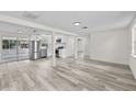 Bright, open-concept living space with modern flooring and stainless steel appliances at 4119 Beacon Square Dr, Holiday, FL 34691