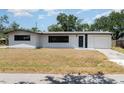 Inviting single-story home with a driveway, well-maintained lawn, and a bright, sunny sky at 2239 Worrington St, Sarasota, FL 34231