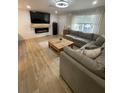 Comfortable living room with a large sectional sofa, fireplace, and natural light from the window at 9153 86Th Ave, Seminole, FL 33777