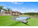 Well-maintained backyard features an above-ground pool, gazebo, and artificial turf at 14095 Tropical Kingbird Way, Riverview, FL 33579