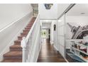 Entry hallway with hardwood floors leads to the staircase and living spaces at 14095 Tropical Kingbird Way, Riverview, FL 33579