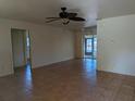 The living room features tile floors, ceiling fan, and a sliding door leading to the outside at 155 Summerset Dr, Punta Gorda, FL 33982
