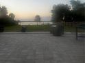 Serene backyard patio with outdoor seating and views of the lake at sunset at 37951 Washington Loop Rd, Punta Gorda, FL 33982