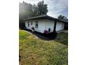Charming home exterior with manicured lawn and decorative flower pots, showcasing curb appeal at 37951 Washington Loop Rd, Punta Gorda, FL 33982