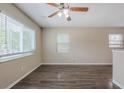 Spacious, naturally lit living room featuring wood-look flooring and neutral paint throughout at 4111 13Th S Ave, St Petersburg, FL 33711