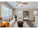 Bright living room featuring a ceiling fan, large windows, and stylish black-and-white decor at 4111 13Th S Ave, St Petersburg, FL 33711