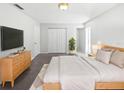 Bright bedroom featuring a light wood bed frame, plush bedding, and ample natural light at 6623 Baybrooks Cir, Temple Terrace, FL 33617