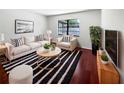 Bright and airy living room with stylish furniture, modern decor, and hardwood floors at 6623 Baybrooks Cir, Temple Terrace, FL 33617