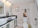 Bathroom featuring double sinks, modern fixtures, and decorative mosaic tiling at 2115 Valrico Heights Blvd, Valrico, FL 33594