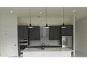 Modern kitchen featuring gray cabinetry, stainless steel appliances, and a large island with a marble countertop at 267 Santa Marta St, Port Charlotte, FL 33954
