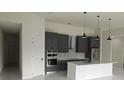 Contemporary kitchen with gray cabinets, stainless appliances, and pendant lights over a white marble island at 267 Santa Marta St, Port Charlotte, FL 33954