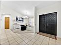 Welcoming foyer with tiled floors and a modern chandelier in dining area at 2900 Hammock Dr, Plant City, FL 33566