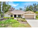 Inviting single-story home with a well-maintained lawn and mature landscaping at 2900 Hammock Dr, Plant City, FL 33566