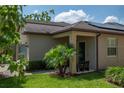 Inviting home featuring a cozy front porch with seating, a well-kept lawn, and fresh landscaping elements at 8410 Red Spruce Ave, Riverview, FL 33578