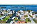 Aerial view of waterfront property with a pool, boat dock, and lush landscaping at 1933 Oregon Trl, Englewood, FL 34224