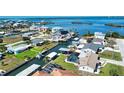 Aerial view of waterfront homes with private docks and lush landscaping on a sunny day at 1933 Oregon Trl, Englewood, FL 34224