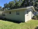 A view of the rear exterior and the well-maintained siding of the home at 4922 Thonotosassa Rd, Plant City, FL 33565
