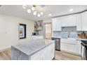 Beautiful kitchen with marble island, stainless steel appliances, custom cabinets and wood flooring at 203 Driftwood W Dr, Palm Harbor, FL 34683