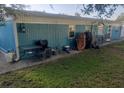 Back exterior view with a small patio, grass area, and outdoor table at 6718 Runningwoods Dr, Tampa, FL 33634