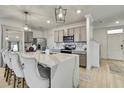 Beautiful kitchen with modern cabinets, a large center island, and stainless steel appliances at 9188 Forge Breeze Loop, Wesley Chapel, FL 33545