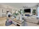Spacious living room with modern decor, a large sectional, and open concept to the kitchen at 9188 Forge Breeze Loop, Wesley Chapel, FL 33545