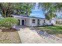 Bright exterior view of a single-Gathering home with a covered carport and well-kept front lawn at 4928 Stolls Ave, Tampa, FL 33615