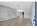 Spacious living room featuring sleek flooring, fresh paint and a fireplace in the distance at 4928 Stolls Ave, Tampa, FL 33615