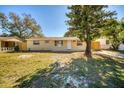 Charming single-story home featuring a well-manicured lawn and mature trees for shade at 6940 82Nd N Ave, Pinellas Park, FL 33781