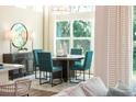 Bright dining area with a round table, four chairs, and a large window offering a view of the outdoors at 1031 Signet, Apollo Beach, FL 33572