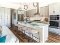 Modern kitchen featuring gray cabinets, granite countertops, an island with seating, and stainless steel appliances at 1031 Signet, Apollo Beach, FL 33572