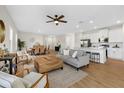 Open-concept living and dining area with modern decor, wood floors, and lots of natural light at 2682 Edwin Ave, North Port, FL 34288