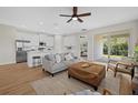 Open concept living area features a sofa, natural light and access to the kitchen and outdoor living at 2682 Edwin Ave, North Port, FL 34288