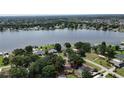 Aerial view showcases the property's proximity to a lake, emphasizing a serene and picturesque neighborhood setting at 3565 E Lake Dr, Land O Lakes, FL 34639