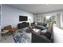 Spacious living room featuring a plush gray sectional, modern furnishings, and a sliding glass door to the backyard at 1780 Draughton Dr, Zephyrhills, FL 33541