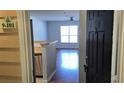 View from entryway showing living room, hard wood floors, and large window at 5000 Culbreath Key Way # 9-101, Tampa, FL 33611