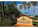Entrance sign for Culbreath Key Bayside Condominiums with palm trees at 5000 Culbreath Key Way # 9-101, Tampa, FL 33611