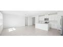 Spacious living room and kitchen area perfect for entertaining and modern living at 7728 Gilchrist Springs Dr, Parrish, FL 34219