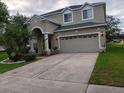 Charming two-story home with a wide driveway and well-maintained lawn at 10415 Lucaya Dr, Tampa, FL 33647