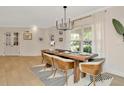 Elegant dining room with modern chandelier and table set for six at 709 S Himes Ave, Tampa, FL 33609