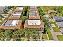 A high-angle aerial view showcasing the well-maintained roofs and landscaping of multiple townhouses at 5016 W Lancaster St # 00, Tampa, FL 33616