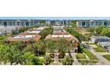 A wide aerial view of multi-Gathering homes featuring manicured landscaping, and street access at 5016 W Lancaster St # 00, Tampa, FL 33616
